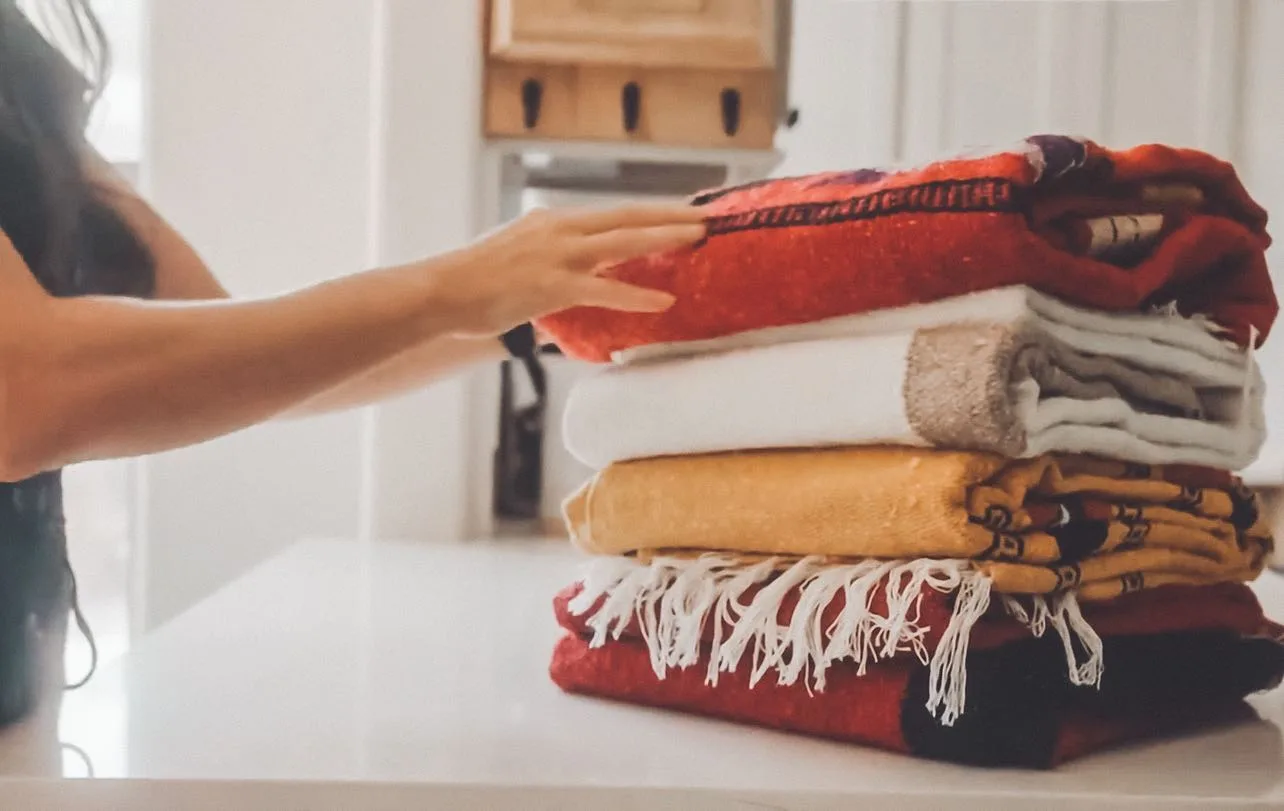 A stack of folded prayer blankets